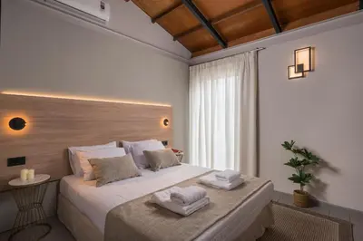 a bedroom with a large bed with two towels on it at Natura Hill Villa IV Sea View in Kounoupidhianá