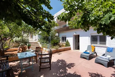 a patio with a table and chairs and a building at Villa Kiara in Tersanas