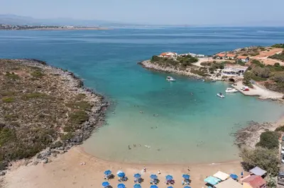 an aerial view of a beach with people and umbrellas at Villa Kiara in Tersanas