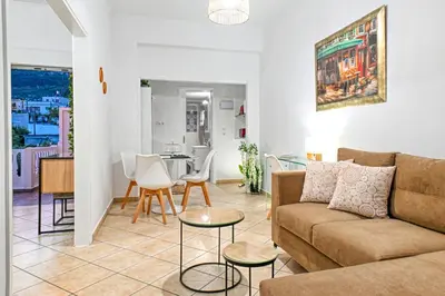 a living room with a couch and a table at Hope apt - 5min to Falassarna Bch in Kissamos