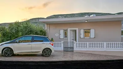 a small white car parked in front of a house at Hope apt - 5min to Falassarna Bch in Kissamos