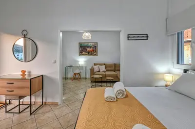 a bedroom with a bed and a living room at Hope apt - 5min to Falassarna Bch in Kissamos