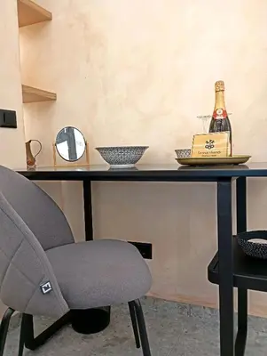 a table with a chair and a bottle of champagne at Domus Vivendi in Chania Town
