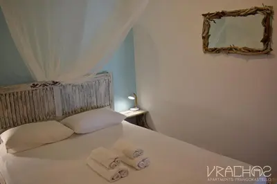 a bedroom with a bed with towels on it at Vrachos Apartments in Frangokastello