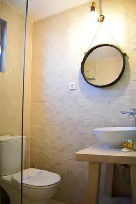 a bathroom with a toilet and a mirror at Pasithea in Frangokastello