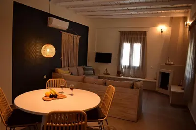 a living room with a table and a couch at Pasithea in Frangokastello