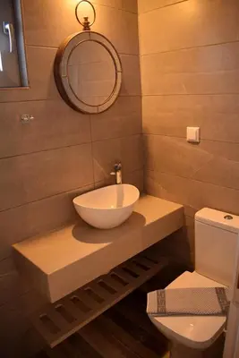 a bathroom with a bowl sink and a toilet at Pasithea in Frangokastello