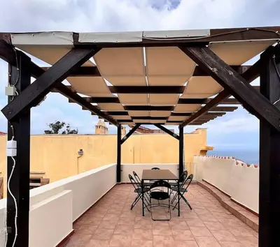 a patio with a table and chairs on a roof at Talos Too, Venetian Residence in Chania Town