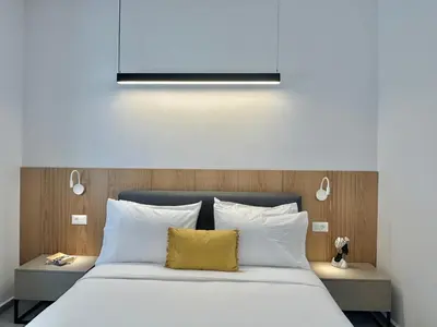 a bedroom with a large bed with a yellow pillow at Camelia Home in Chania Town