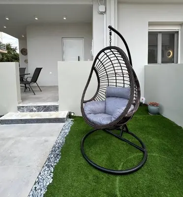 a swing chair sitting on the grass in a yard at Camelia Home in Chania Town