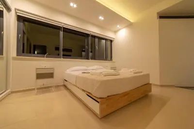 a bedroom with a bed and a large window at Luxury Villa Mirror - 200meters From The Beach in Daratso