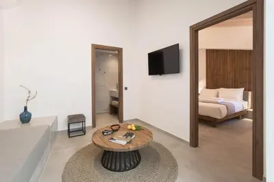 a room with a bed and a table and a mirror at Evge Experience Boutique Hotel in Kafoúros