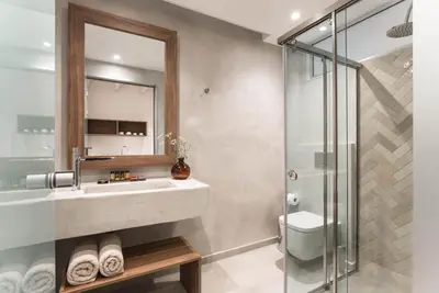 a bathroom with a sink and a shower at Evge Experience Boutique Hotel in Kafoúros