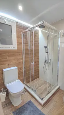 a bathroom with a shower and a toilet at Fully renovated Studio in Platanias in Plataniás