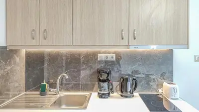 a kitchen with a sink and a counter top at Fully renovated Studio in Platanias in Plataniás