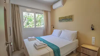 a bedroom with a bed with towels on it at Fully renovated apartment in Platanias 1 in Plataniás