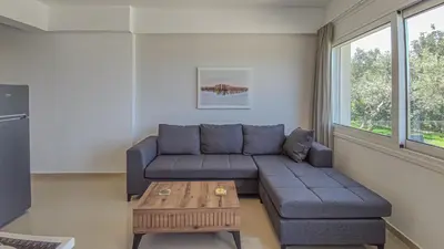 a living room with a couch and a coffee table at Fully renovated apartment in Platanias 1 in Plataniás