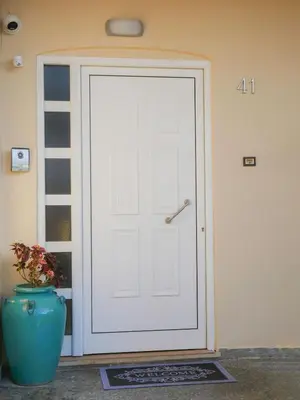 a white door in a room with a vase at Giovanni City House near Chania City Center in Chania Town