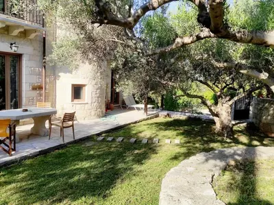 a backyard with a table and a tree at VILLA IRIS in Vryses