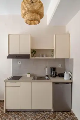 a kitchen with white cabinets and a sink at Four Seasons in Chania Town