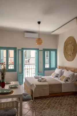 a bedroom with a large bed and a table at Four Seasons in Chania Town