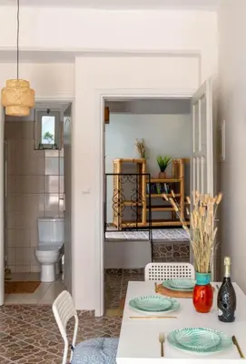 a dining room with a table and a bathroom at Four Seasons in Chania Town