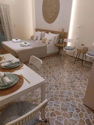 a living room with a bed and tables and chairs at Four Seasons in Chania Town