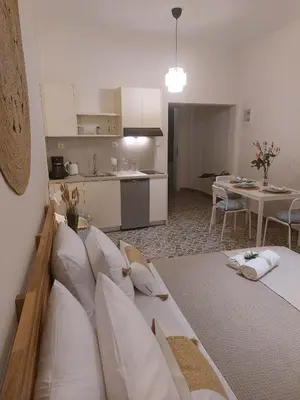 a living room with a couch and a kitchen at Four Seasons in Chania Town