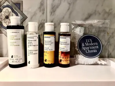 four bottles of moisturizers sitting on top of a counter at Lux and modern apartment Chania in Chania Town