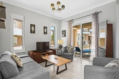 a living room with a couch and a tv at Villa Blue Dreams in Maleme in Ayiá