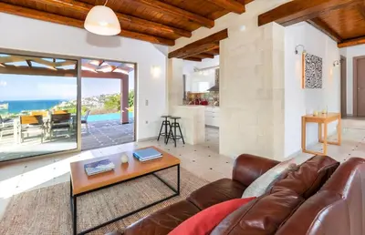 a living room with a couch and a table at Villa Vereniki in Áyios Andhréas