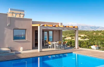 a villa with a swimming pool and a house at Villa Vereniki in Áyios Andhréas