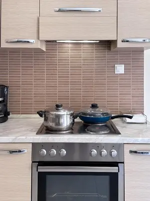 a stove with two pots on top of it in a kitchen at KOSTAS HOUSE in Chania Town