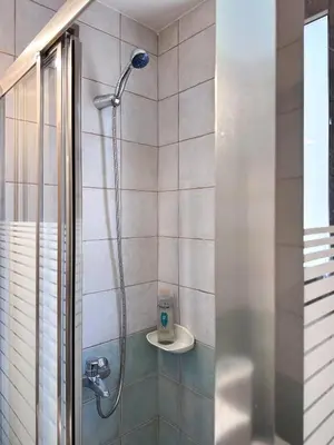 a shower in a bathroom with a glass door at KOSTAS HOUSE in Chania Town