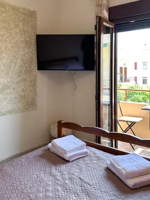 a bedroom with a bed with two towels on it at KOSTAS HOUSE in Chania Town