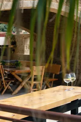 a glass of wine sitting on a wooden table at Kotinos Luxury Villa in Chania Town