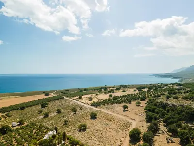 an aerial view of a field and the ocean at Serenitas, family house with great views in Sfakiá