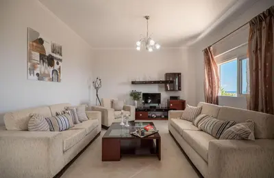 a living room with two couches and a coffee table at Serenitas, family house with great views in Sfakiá