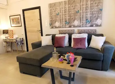 a living room with a couch and a coffee table at Alena home in Chania Town