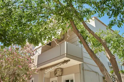 a building with a balcony on the side of it at Luxurious house near the sea in Kato Daratso