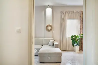 a living room with a couch and a chair at Luxurious house near the sea in Kato Daratso