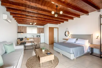 a bedroom with a bed and a living room at Superb apartmentS Kriaras sea view in Sfakia in Khóra Sfakíon