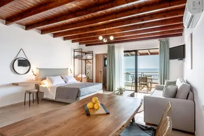 a bedroom and living room with a bed and a table at Superb apartmentS Kriaras sea view in Sfakia in Khóra Sfakíon