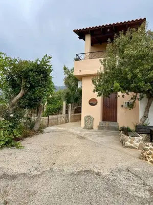 a small house with a gate and a driveway at almond home in Livadia