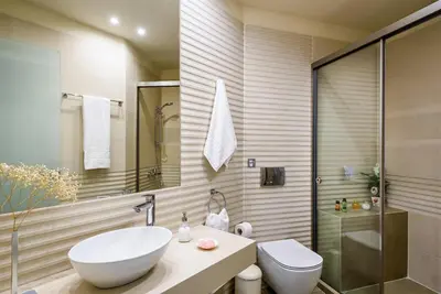 a bathroom with a white sink and a toilet at Studios Rika in Plataniás