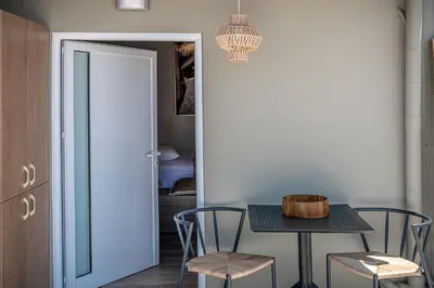 a dining room with a table and chairs at Lavender suite sea view in Plataniás