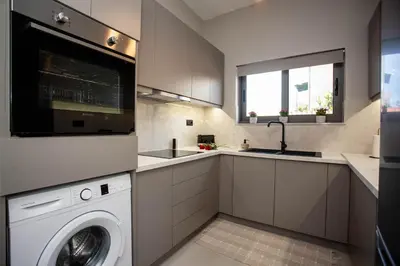 a kitchen with a washing machine and a sink at Makel Apartment in Chania Town