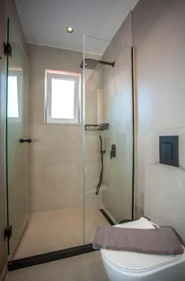 a bathroom with a shower and a toilet at Makel Apartment in Chania Town