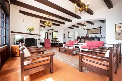 a large living room with red furniture and a fireplace at Casa Bella Vista in Kalathas