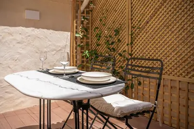 a table with plates and wine glasses on it at La Torre del Kastelli in Chania Town